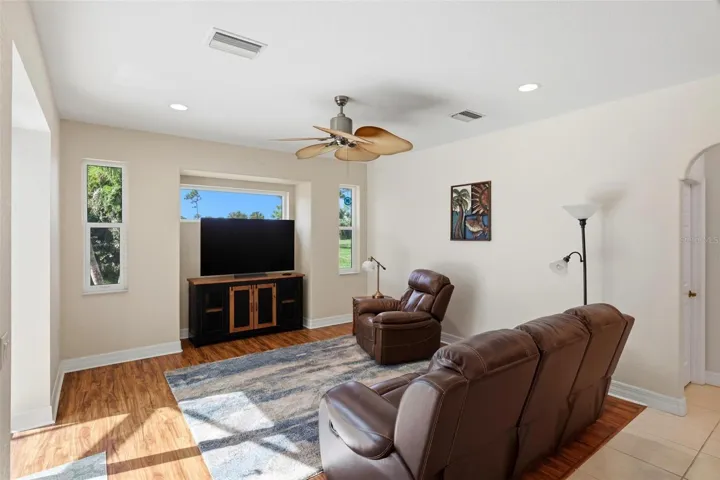 Family room.... Transom window above the tv for extra lighting.... All windows in the home are hurricane impact windows....