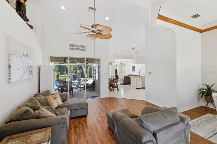 Living room with sliding glass doors out to your lanai and private swimming pool...