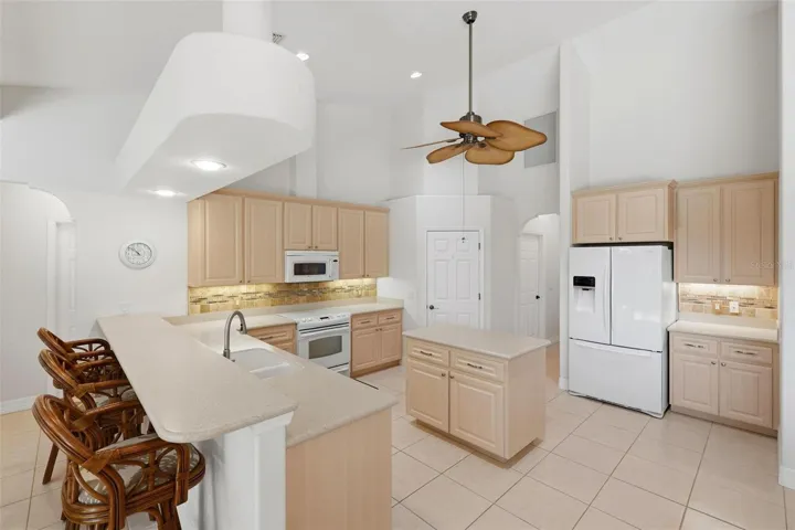 Kitchen has Corian Countertops...beautiful backsplash.... pull-out shelves on bottom of cabinets....