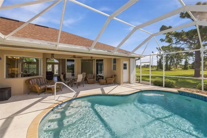 Across the pool is the covered area of your lanai and to the right is the pool bath...