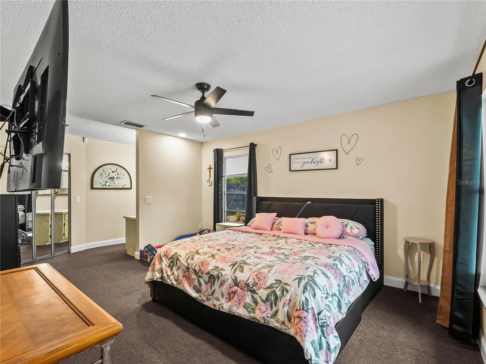 Primary bedroom: walk-in closet behind mirrored doors, vanity to the right of the closet.