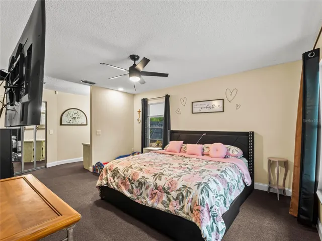 Primary bedroom: walk-in closet behind mirrored doors, vanity to the right of the closet.