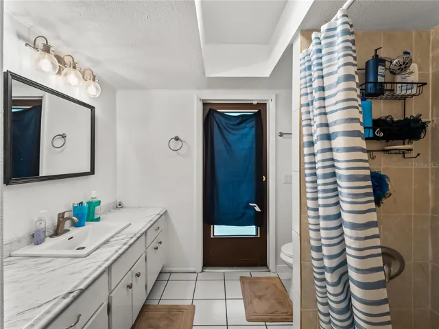 Guest bath looking from the entry at the door to the pool deck.