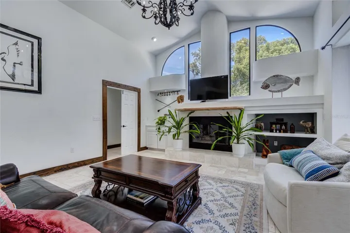 Large family room with oval windows and gas fireplace!