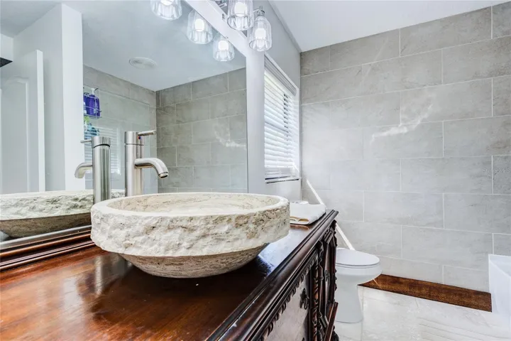 Travertine sink and antique wood vanity!
