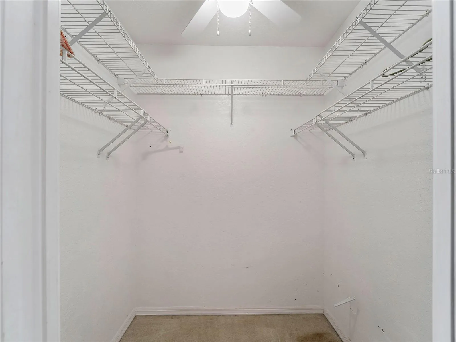 WalkInCloset_134TocopillaStreet_PuntaGorda_BuiltInShelving_Entry.jpg