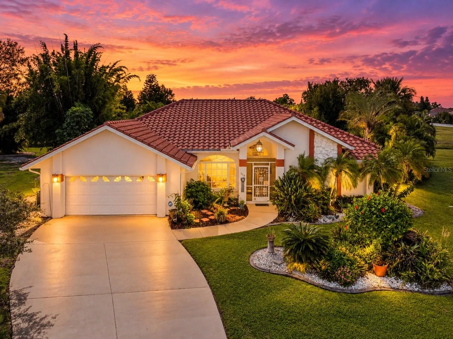 FrontExterior_134TocopillaStreet_PuntaGorda_Landscaped_Twilight.jpg