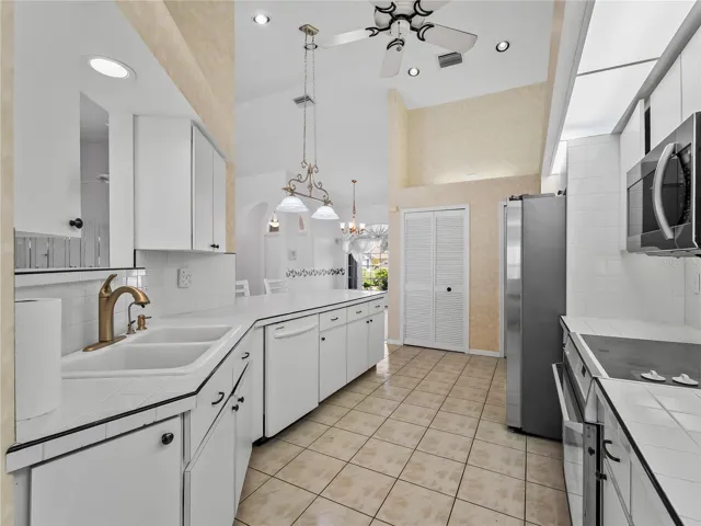 Kitchen_134TocopillaStreet_PuntaGorda_WhiteCabinetry_Corner.jpg