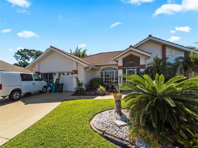 FrontExterior_134TocopillaStreet_PuntaGorda_TropicalLandscaping_Corner.jpg