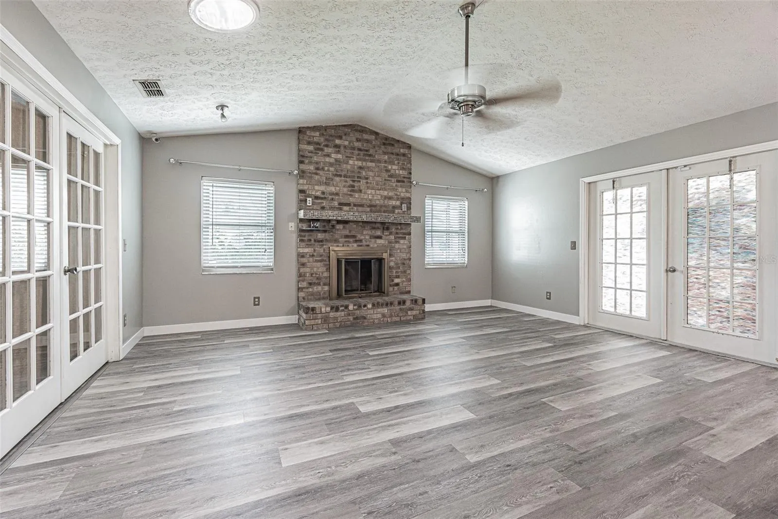 family room with wood-burning brick fireplace