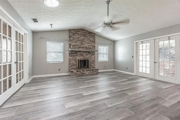 family room with wood-burning brick fireplace