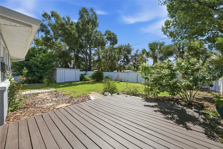 Back Deck with lots of green space and mature trees