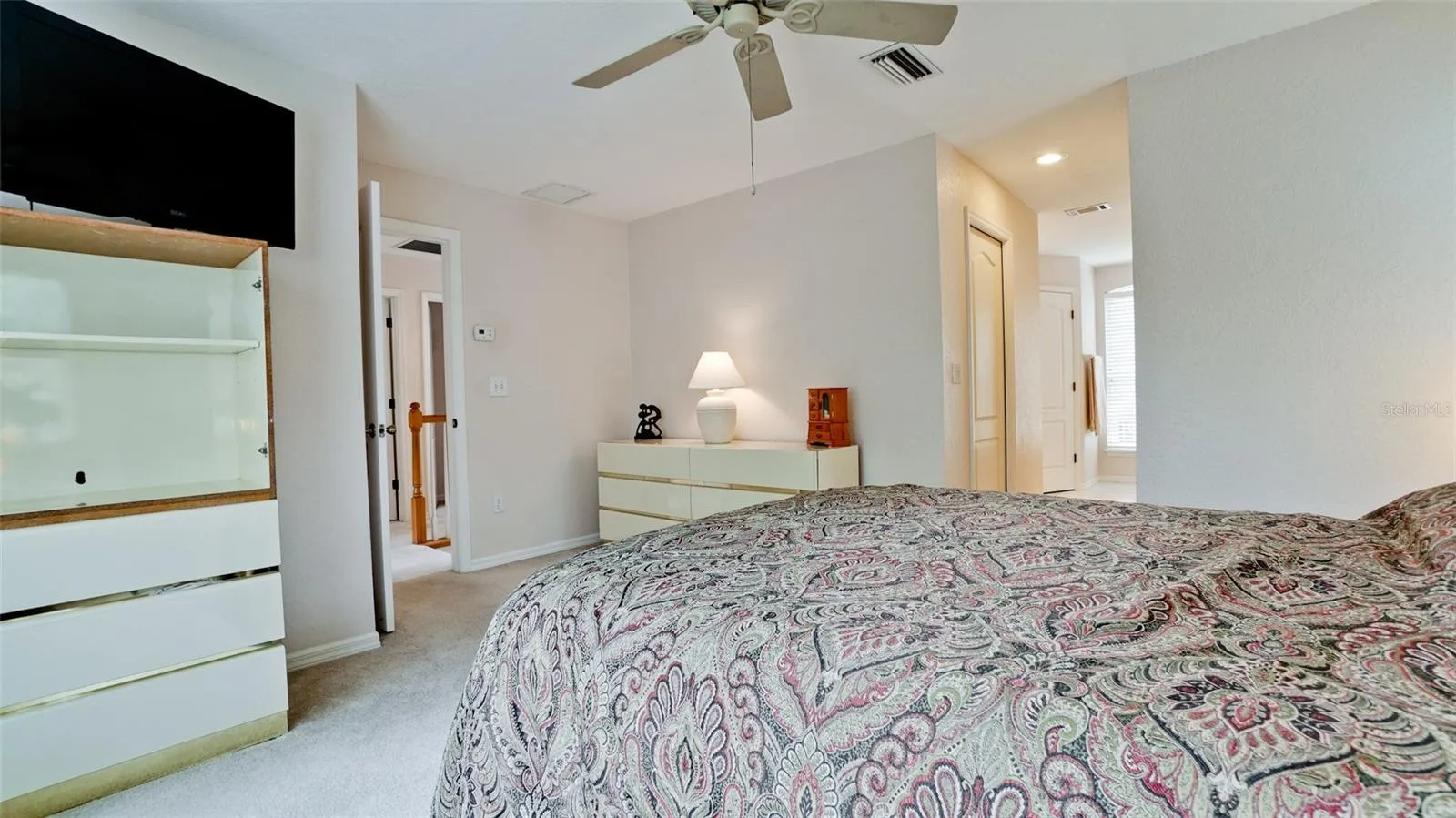 Primary vanity area with large window for natural light
