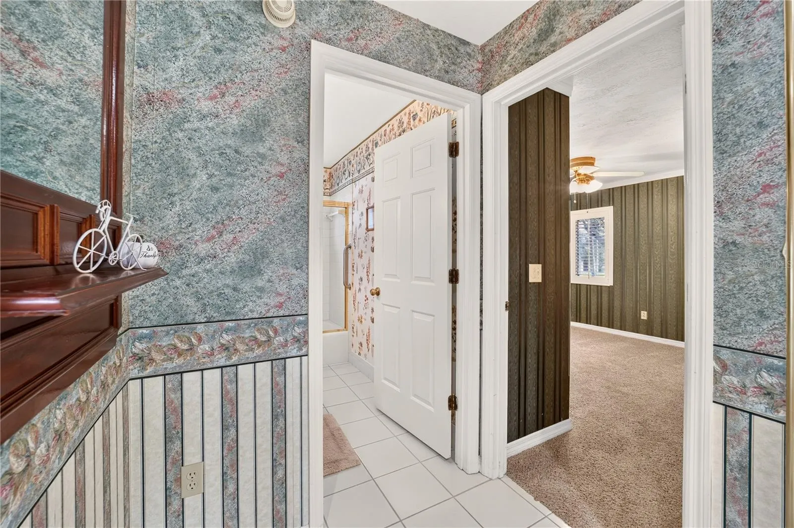 View into the bathroom at the entrance and front bedroom