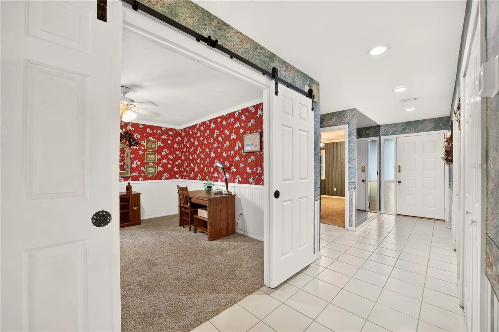 View from the dining area to the front entrance and the office or den.