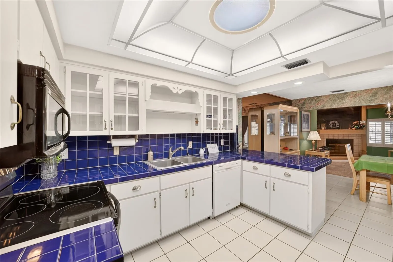 Spacious kitchen with tile floors, solar tube skylight and lots of cabinet space with pantry