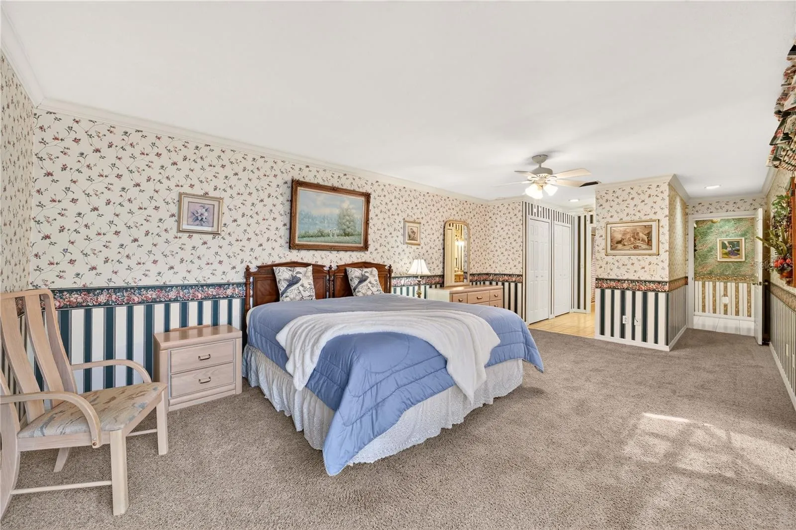 This view shows the entry to the bathroom with several closets for clothes, linen and storage.