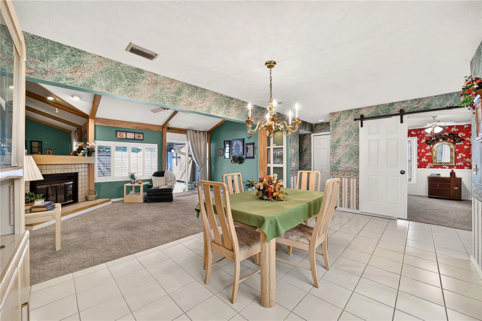 The dining area is tiled and right beside the living room and kitchen