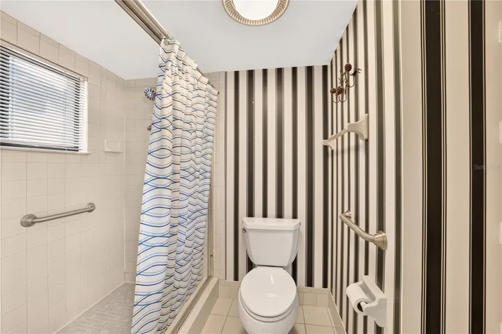The shower and toilet closet have grab bars for safety