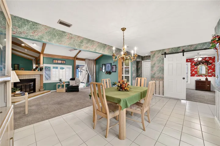 The dining area is tiled and right beside the living room and kitchen