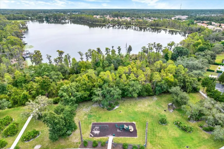 Aerial view of the Waters Edge playground and green space with West Moon lake beyond