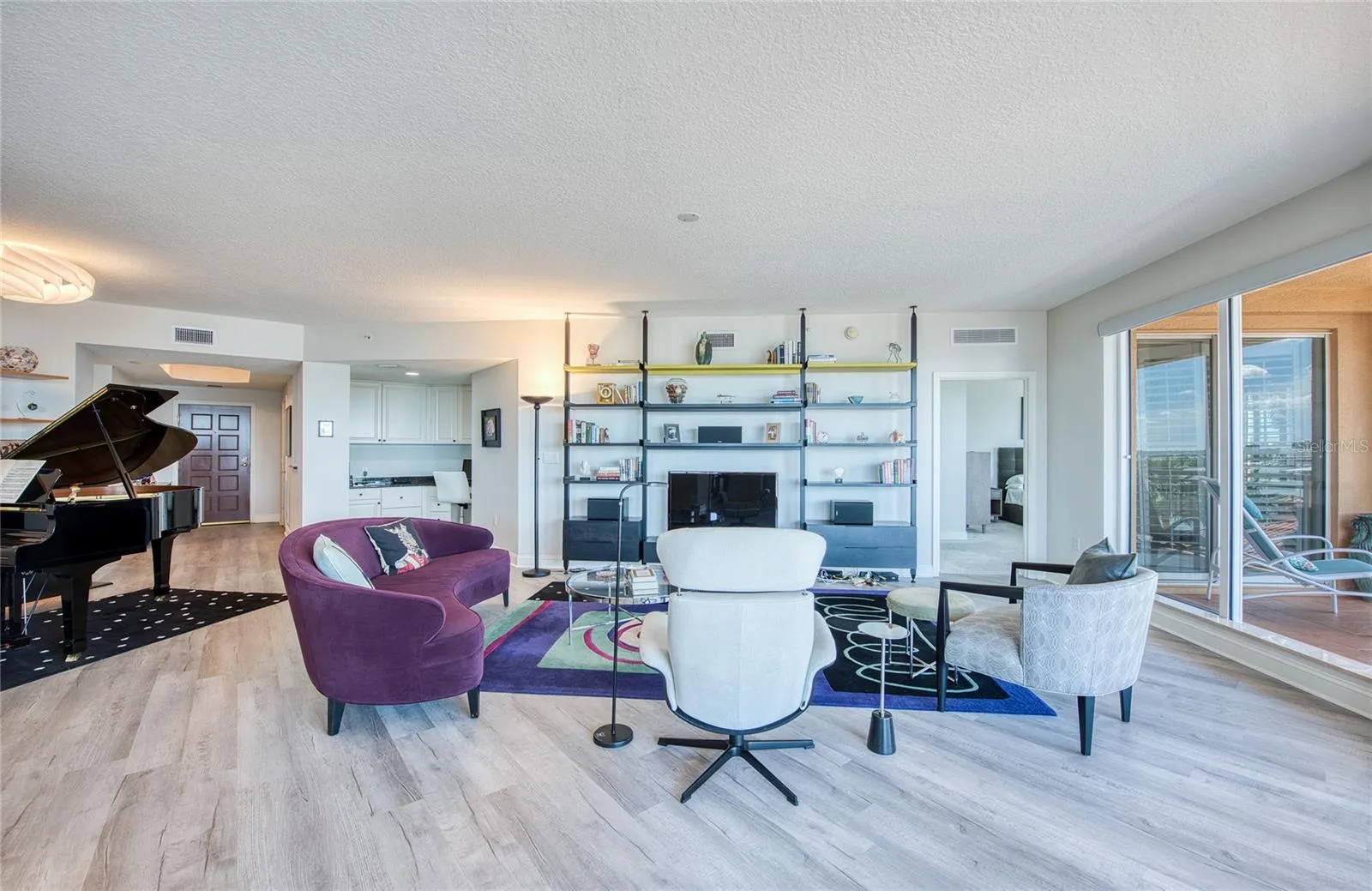 A Wall of Sliding Glass Doors provides lots of light and great Palm Tree and Water Views.