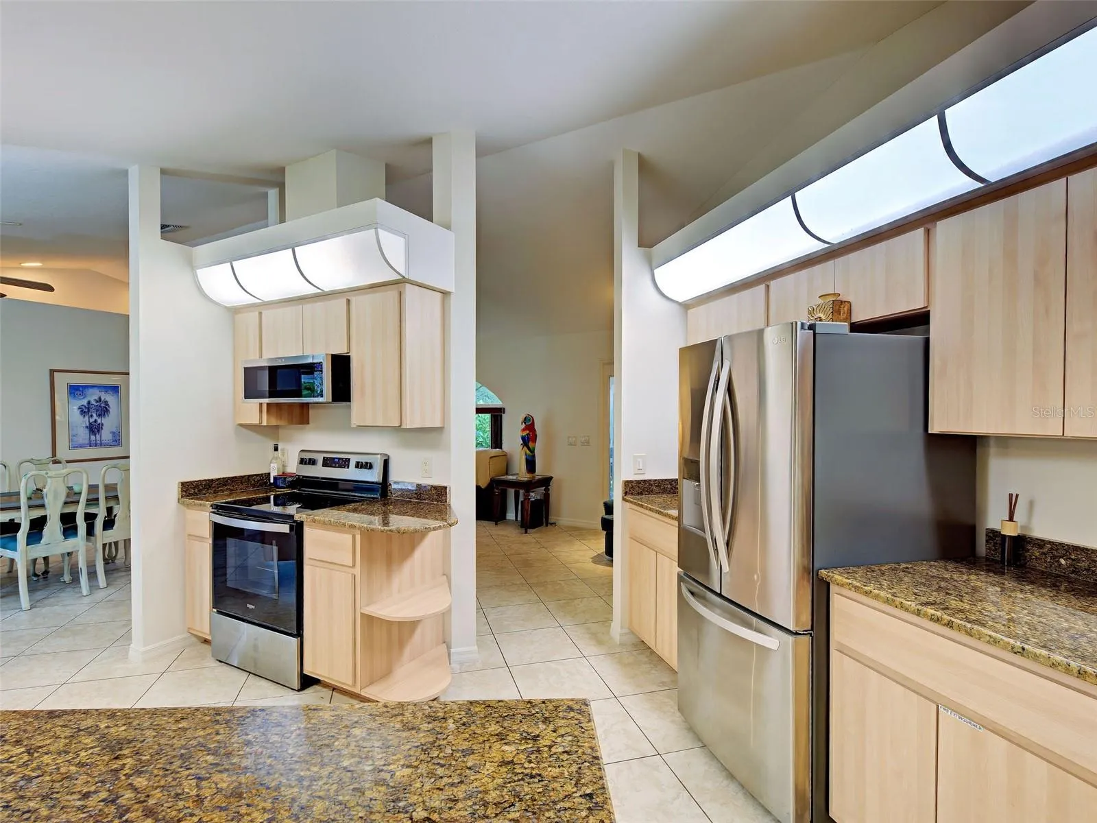 The kitchen is conveniently located off of the dining room, and the counter tops are granite and newer stainless-steel appliances.