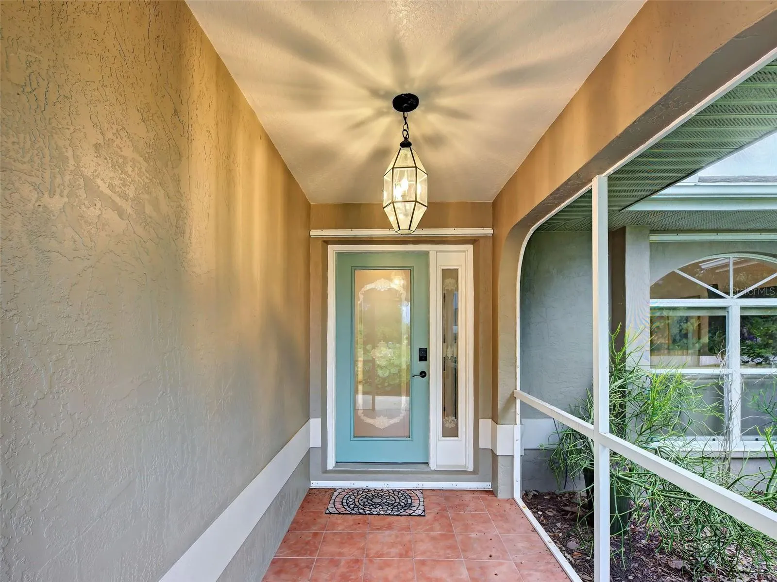 There is lovely tile in the front porch and a welcoming door with a side light.