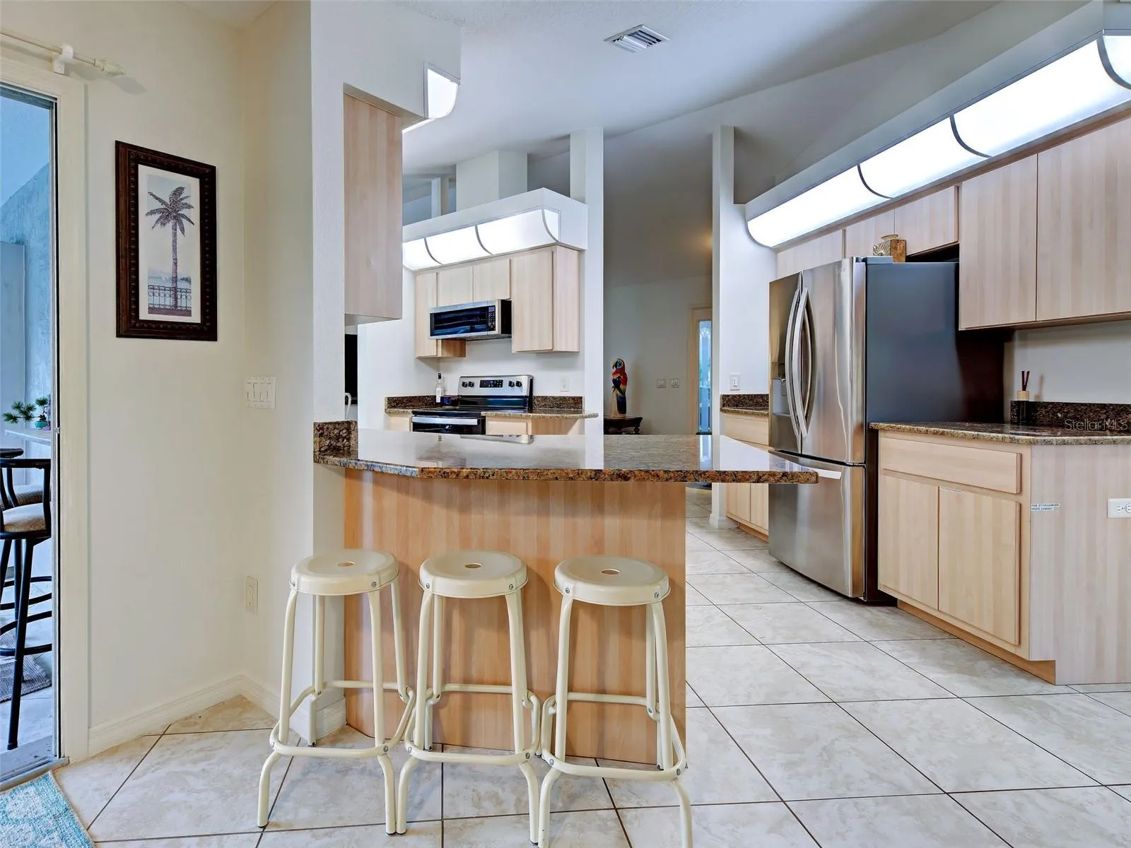 There is room at the kitchen counter for stools to use for casual dining.