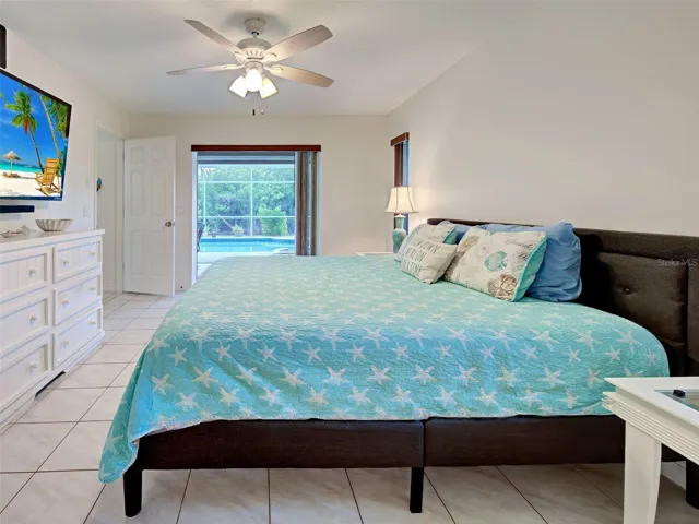 The primary ensuite bedroom has sliding glass doors open to the lanai.