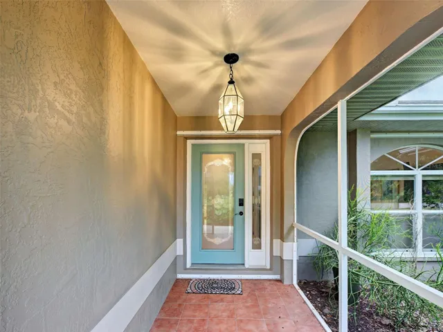 There is lovely tile in the front porch and a welcoming door with a side light.