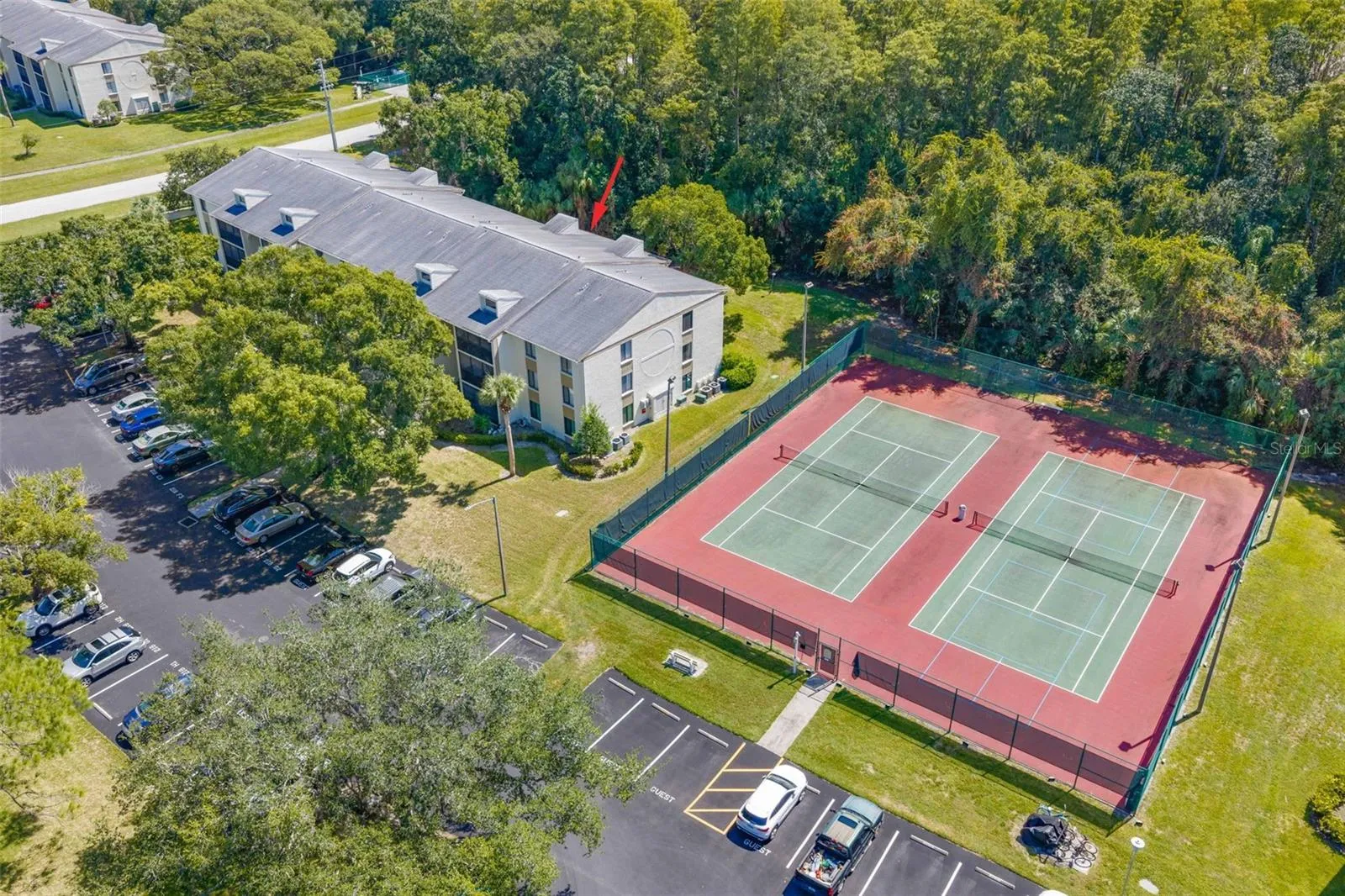 Building 218 is  tucked beside the community tennis courts, with Brooker Creek Preserve creating a lush natural backdrop behind the property.