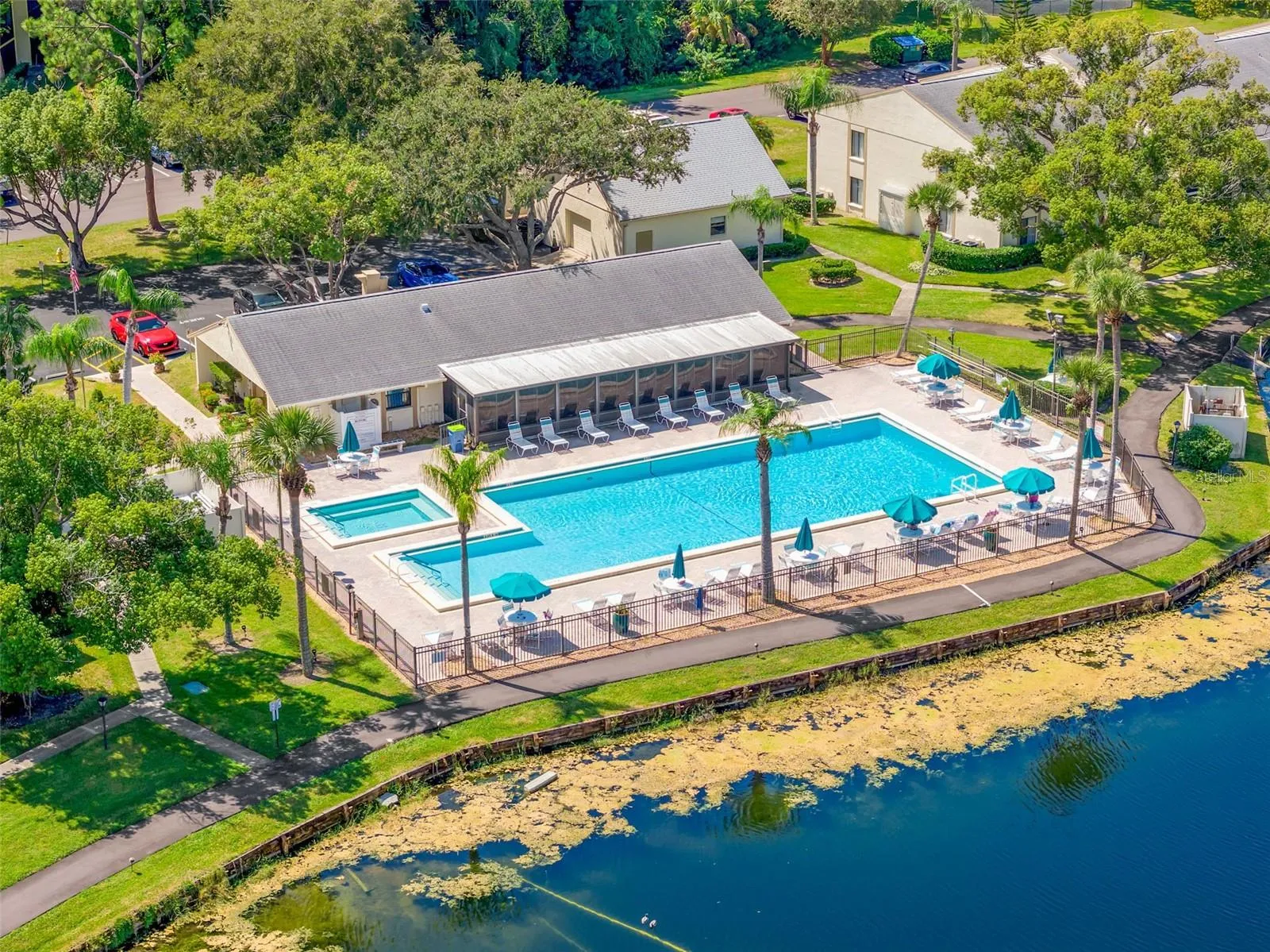 The lakeside recreation area features a heated community pool, jacuzzi, generous deck seating, and a clubhouse overlooking the water—a welcoming spot to swim, relax, or gather with friends.