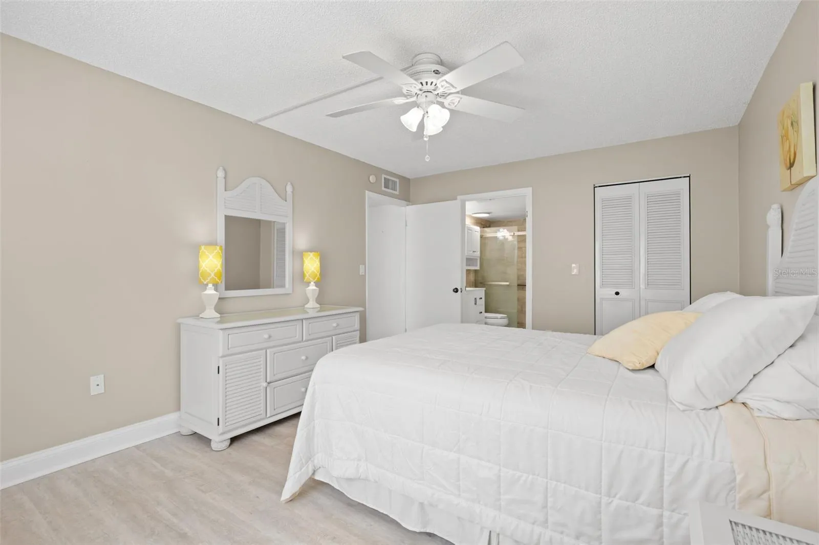 The primary suite includes direct access to the updated bath and a large walk-in closet, adding both privacy and practical storage.
