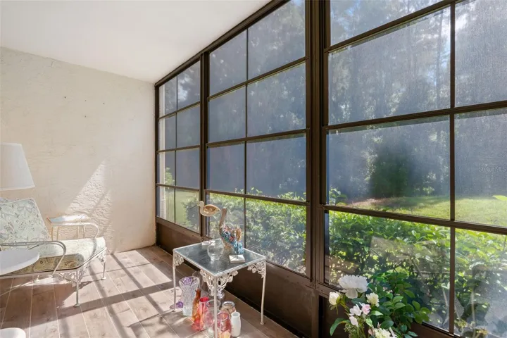 The screened lanai is wrapped in oversized screened windows, bringing in loads of natural light while framing the green, preserve-side setting just beyond.