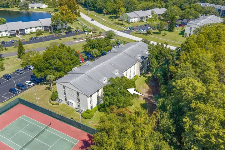 The condo enjoys a tucked-away setting along Brooker Creek Preserve, with tennis courts nearby and mature trees and open green space surrounding the community.