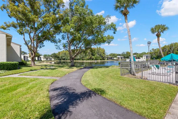 Paved walking paths wind through the community’s landscaped grounds and around the lake, offering an easy way to enjoy the scenery just beyond the pool.
