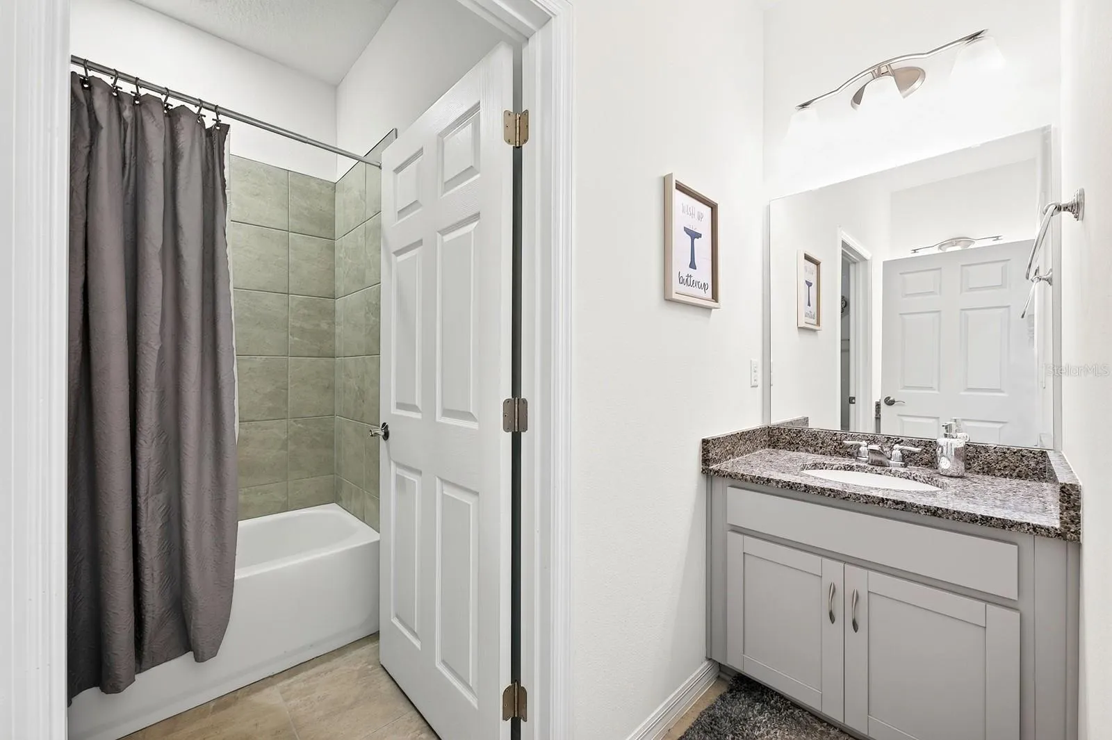 Bathroom 2 features dual vanities and a tub with shower.