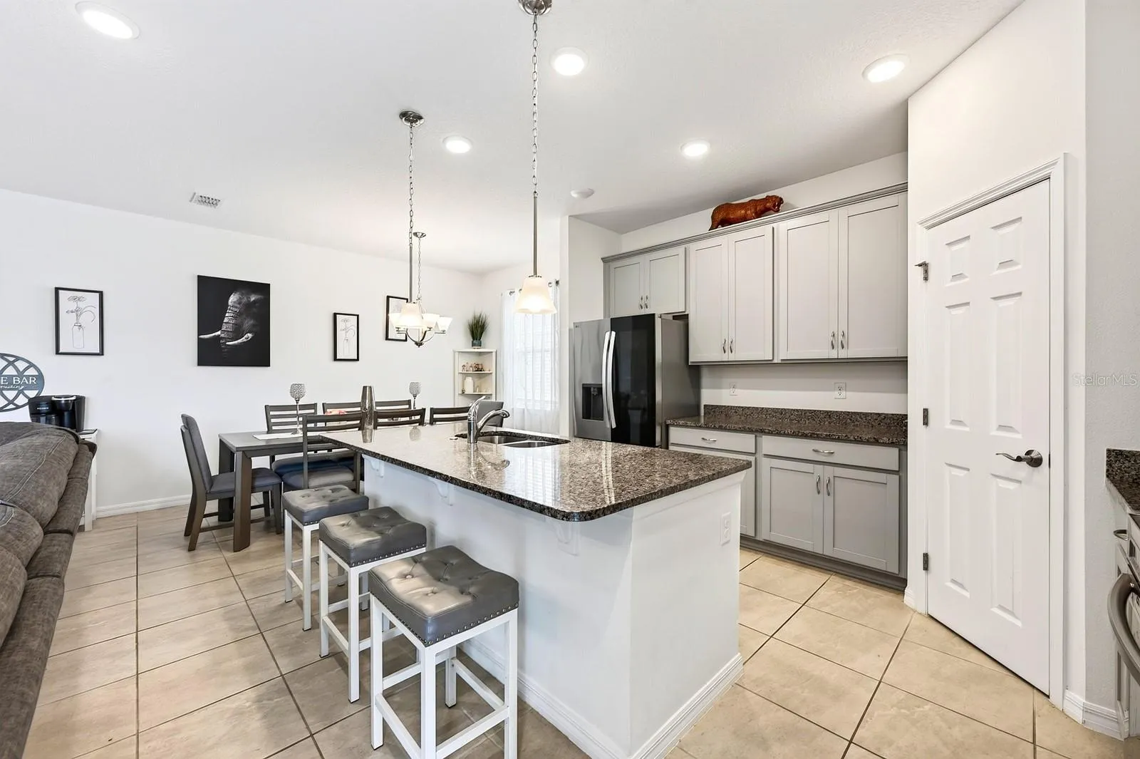 At the heart of the home, the spacious Kitchen offers an abundance of cabinetry and counter space, a large center island, BREAKFAST BAR, stainless steel appliances and a convenient WALK-IN PANTRY, keeping everyone connected to the main living spaces.