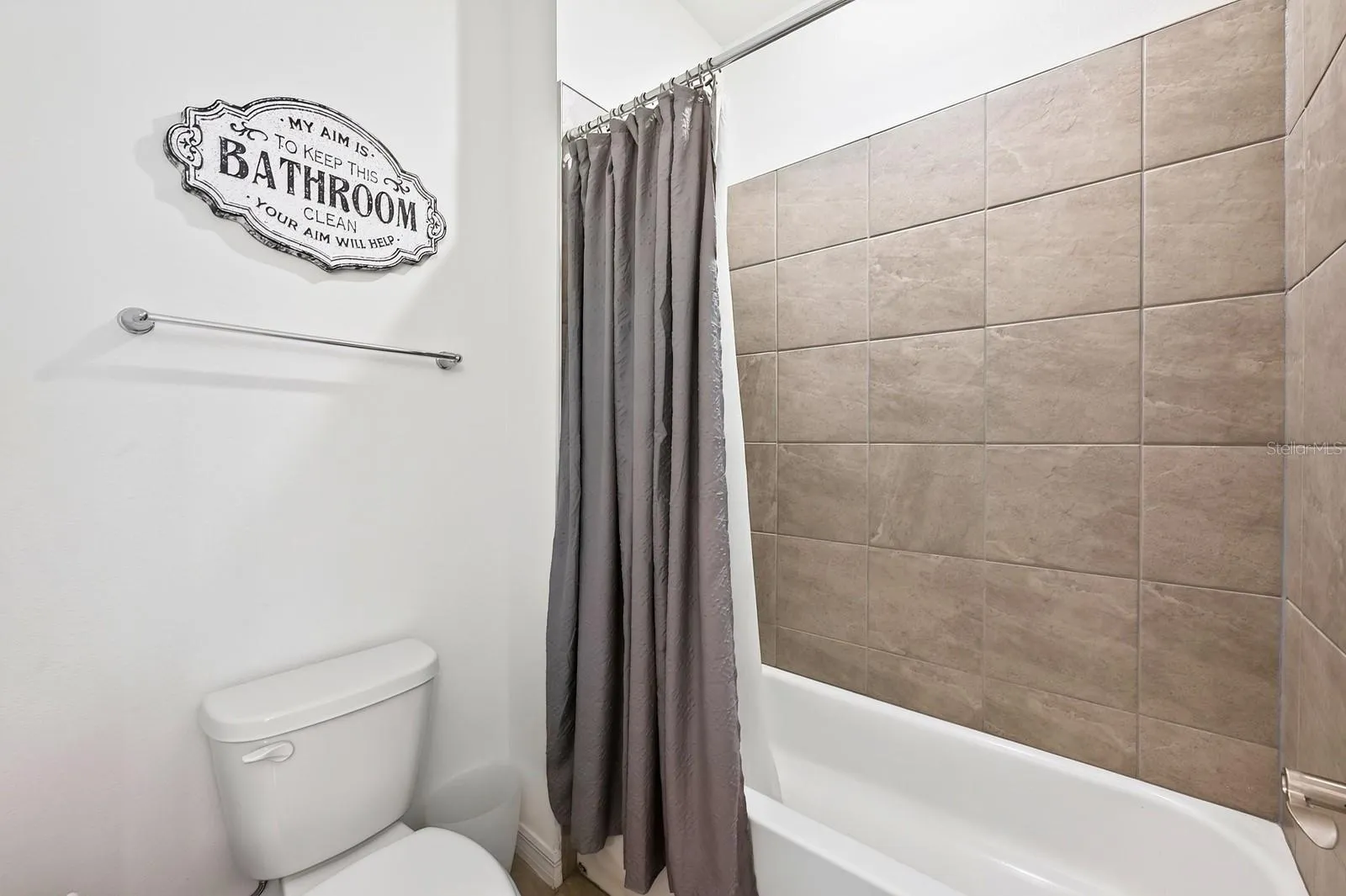 Bathroom 2 features dual vanities and a tub with shower.