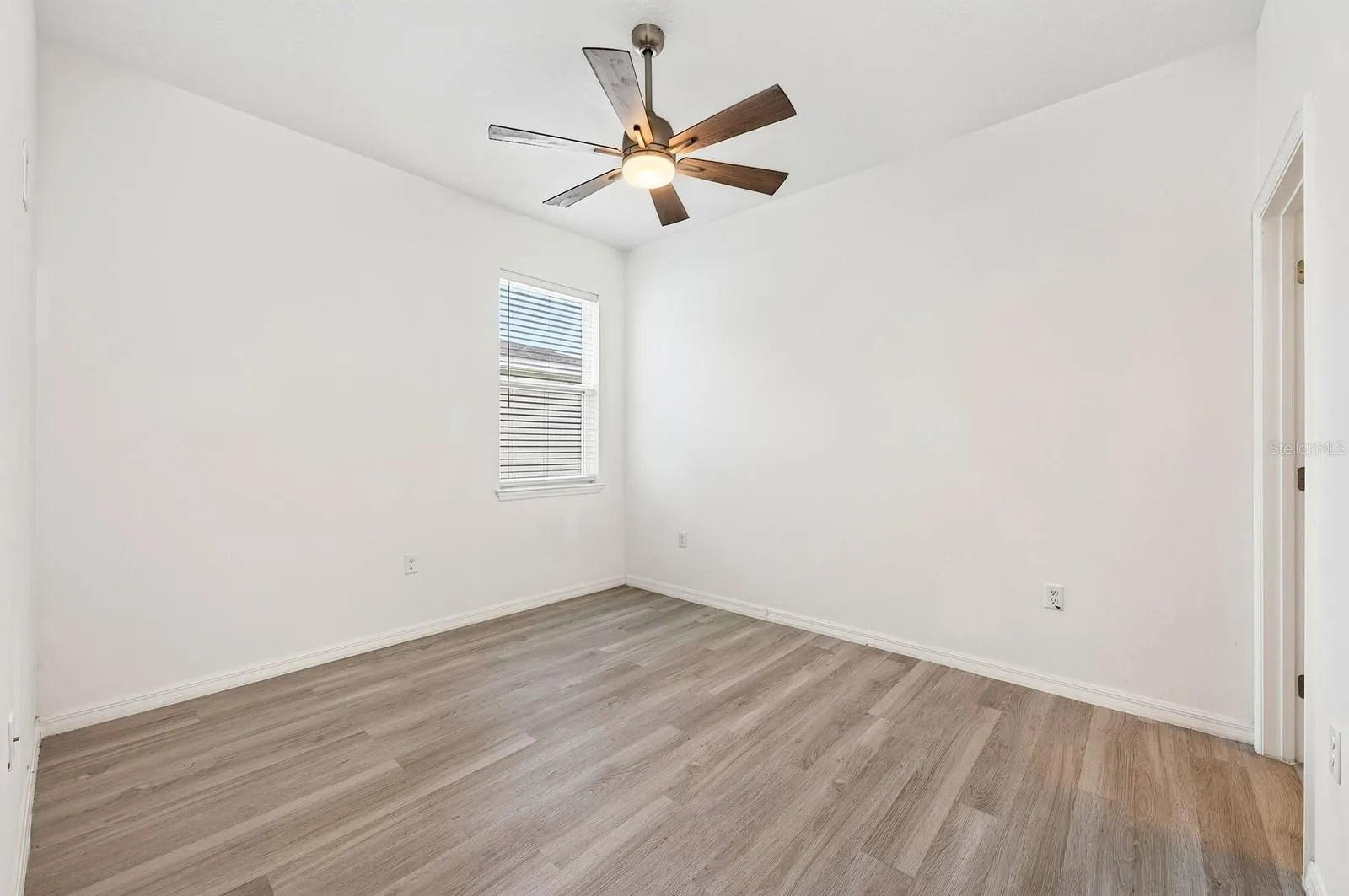 The fourth Bedroom is tucked near the garage entrance and features its own PRIVATE EN-SUITE BATH, making it an ideal GUEST SUITE, MULTIGENERATIONAL SPACE or HOME OFFICE.