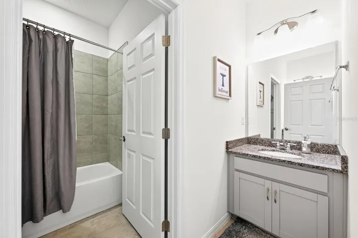 Bathroom 2 features dual vanities and a tub with shower.