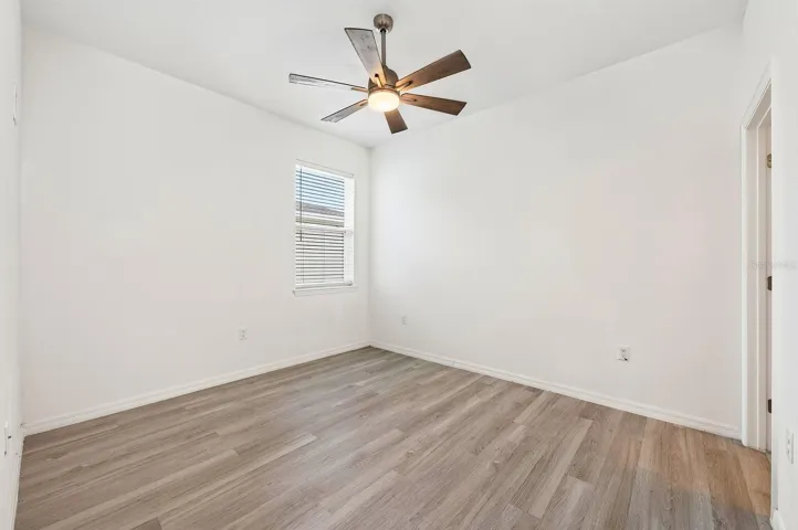 The fourth Bedroom is tucked near the garage entrance and features its own PRIVATE EN-SUITE BATH, making it an ideal GUEST SUITE, MULTIGENERATIONAL SPACE or HOME OFFICE.