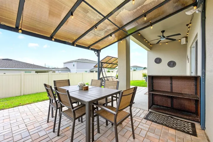 Enjoy al fresco dinners under the pergola, where the covered outdoor space creates the perfect setting for gathering with family and friends.