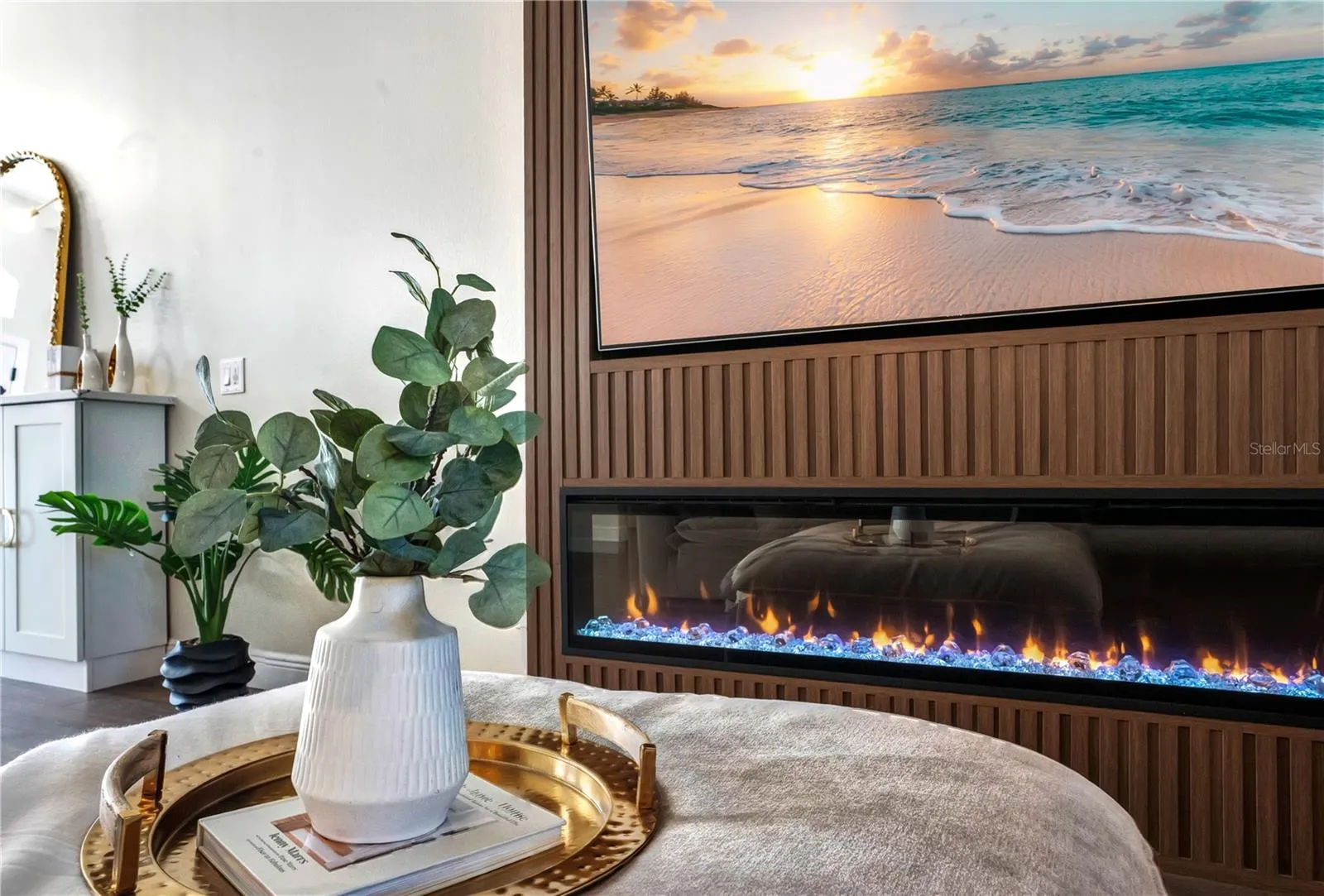 Linear electric fireplace with ambient flame.