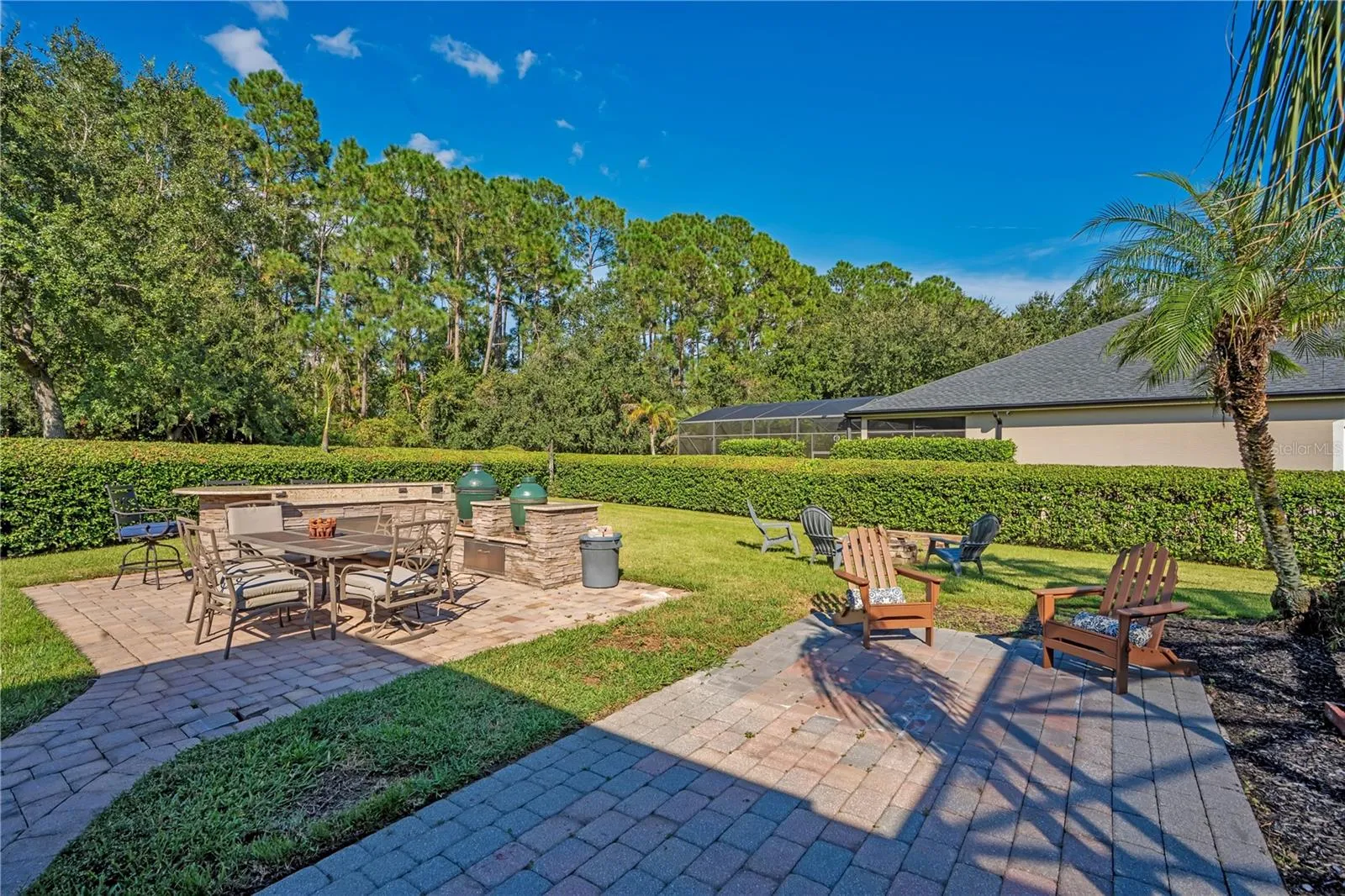 Paver patios and fire pit in a private yard.