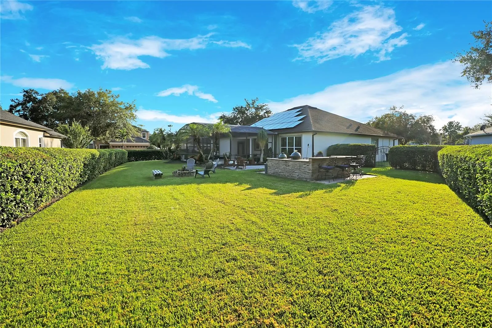Deep, private backyard with lush lawn.