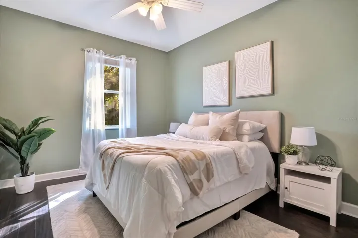Bedroom 3 with ceiling fan and natural light.