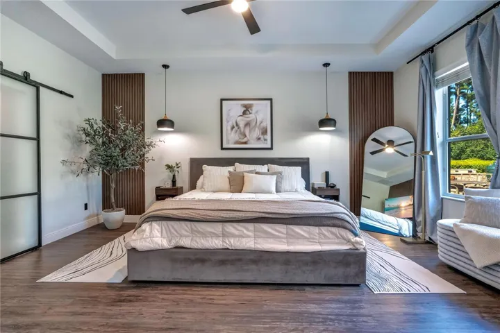 Primary suite with barn-door walk-in closet.