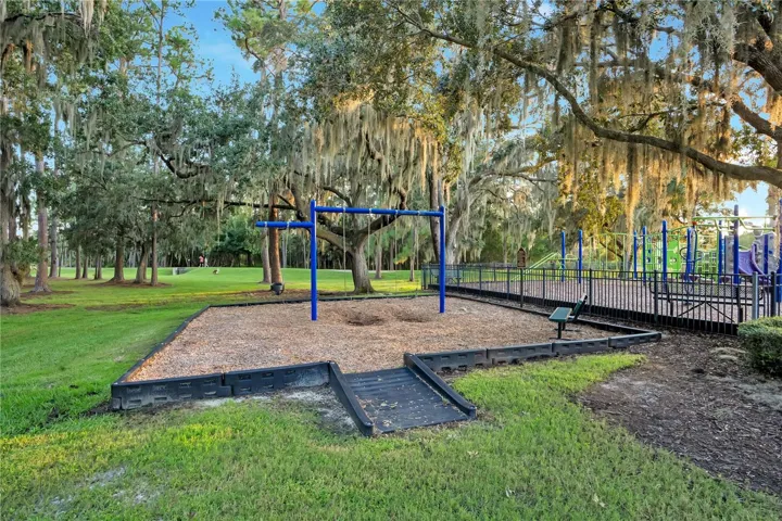 Park with swings under mature oaks.